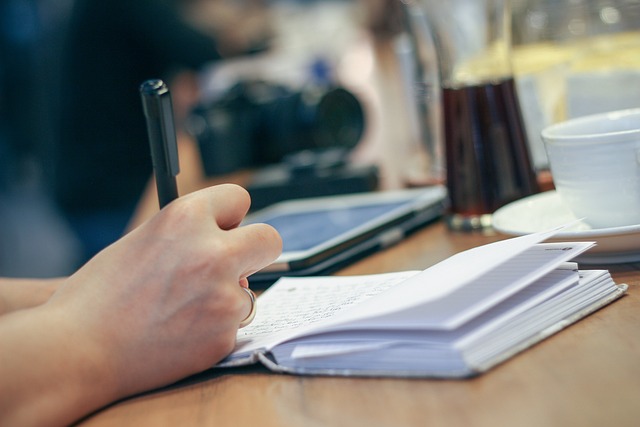 open journal with handwritten notes on a wooden desk