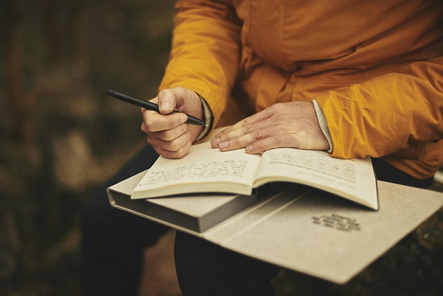 Canadian adult reading a psychology workbook beside a window overlooking autumn trees