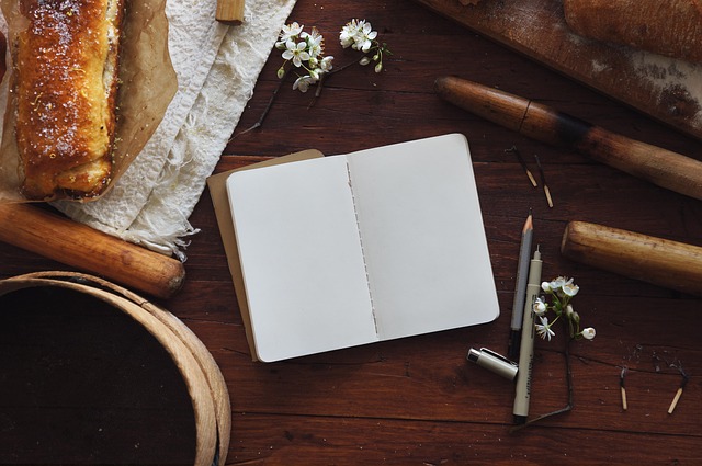 open notebook with handwritten goals and coloured sticky notes on a wooden desk